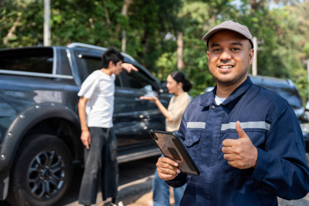 A smiling Roadside Neighbor provider giving a thumbs up beside a truck