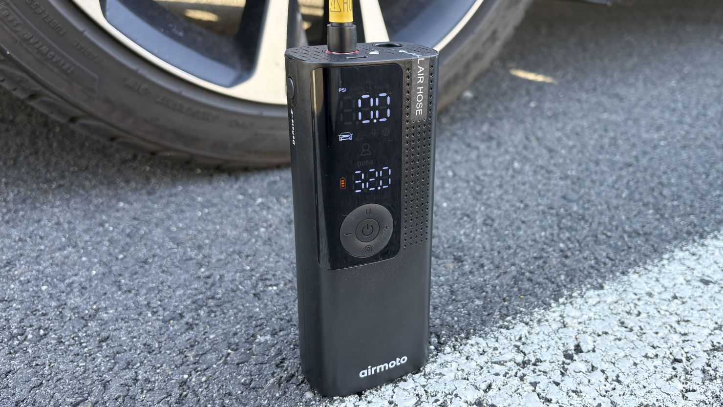 A provider using a cordless inflator on a tire