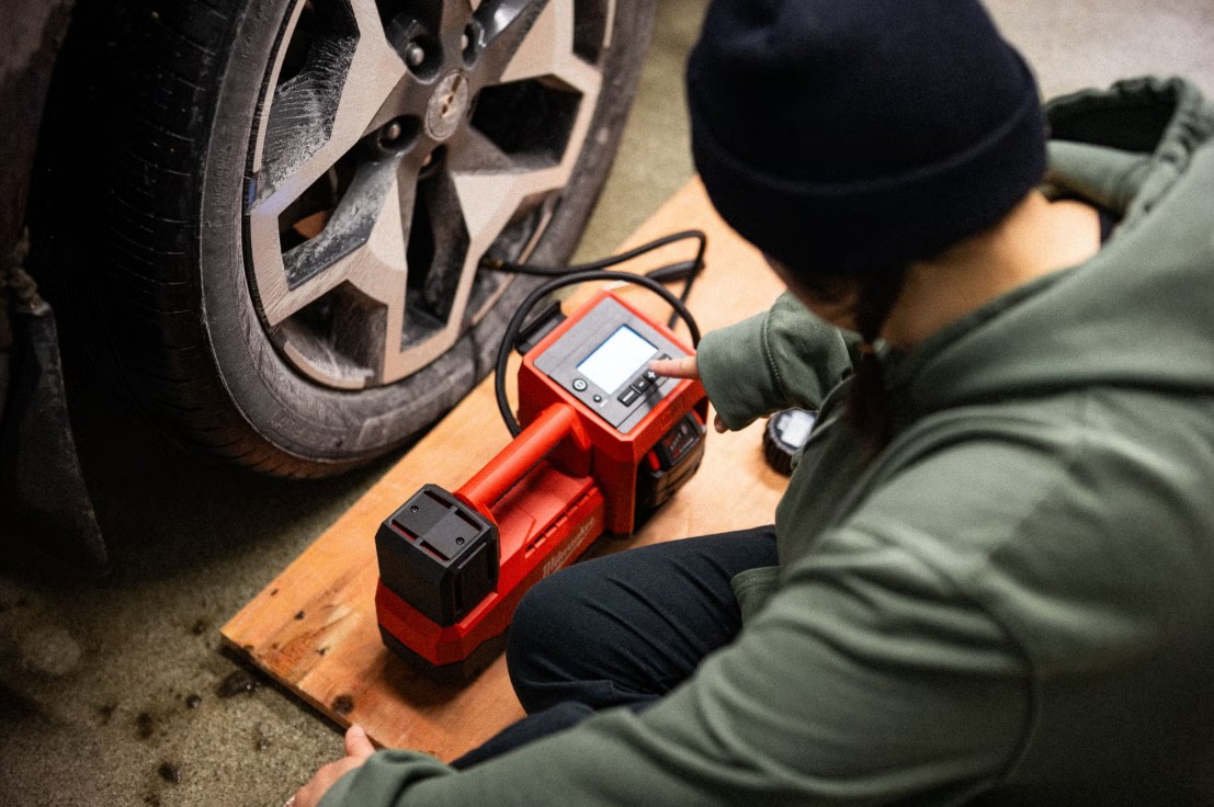 A portable digital tire inflator on the pavement