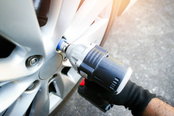 A cordless impact wrench with sockets and battery