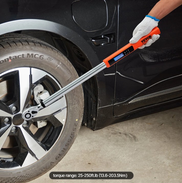 A torque wrench tightening a wheel lug nut