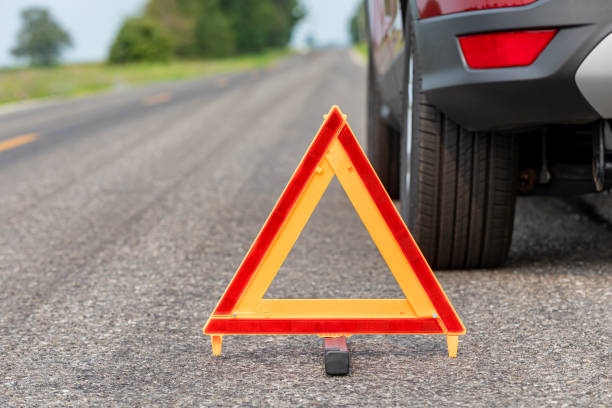 A reflective safety triangle placed on the road behind a vehicle